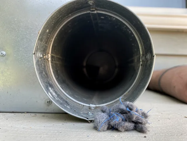 Derby Dryer Vent Cleaning technician using specialized equipment to clear severe dryer vent blockage in Derby